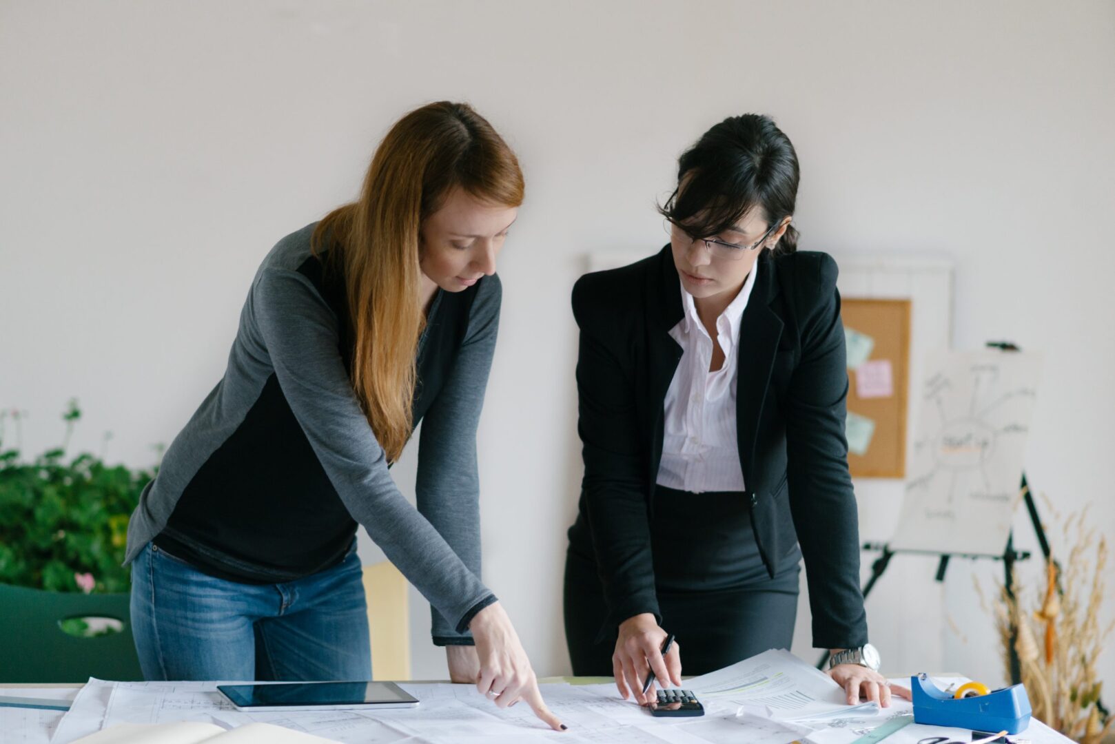 Two women are working on a project together. Two women are working on a project together.