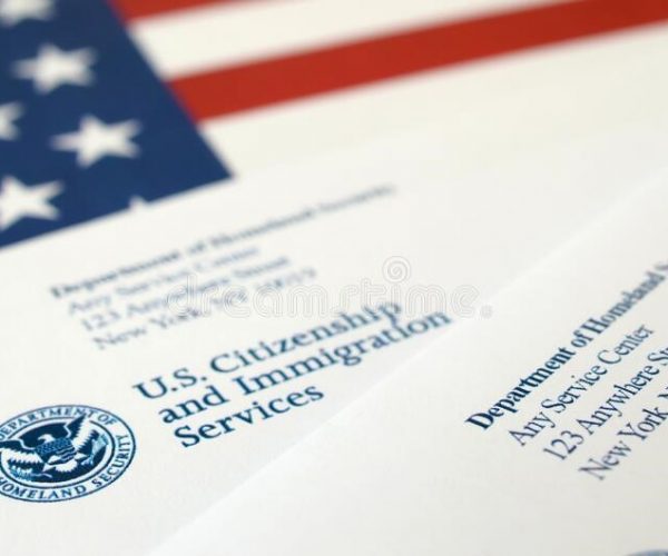 A close up of an american flag and some papers