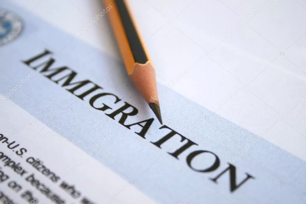 A pencil is on top of the word immigration. A pencil is on top of the word immigration.