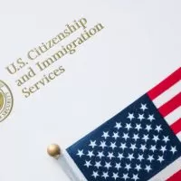 A close up of an american flag on top of a white paper.