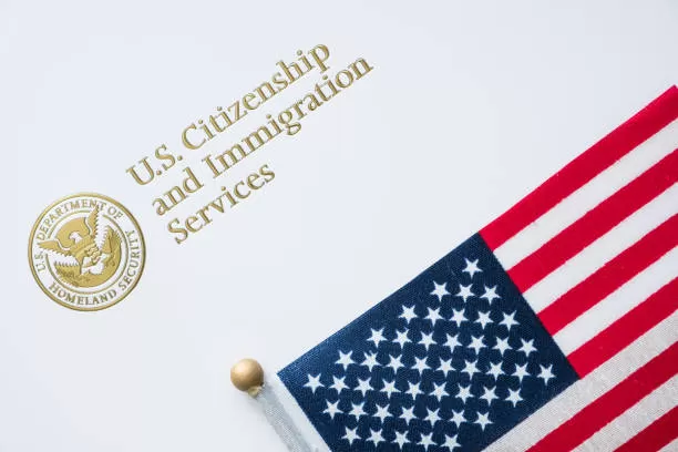A close up of an american flag on top of a white paper. A close up of an american flag on top of a white paper.