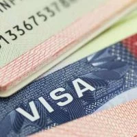 A close up of the visa on top of some papers