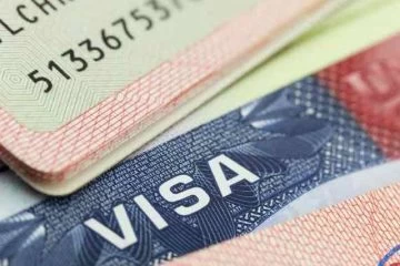 A close up of the visa on top of some papers