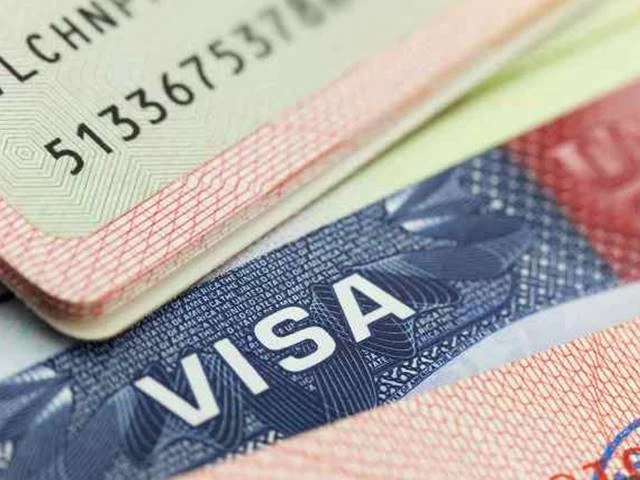 A close up of the visa on top of some papers A close up of the visa on top of some papers
