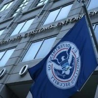 A flag flying in front of the us customs office.