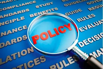 A magnifying glass over the word policy.