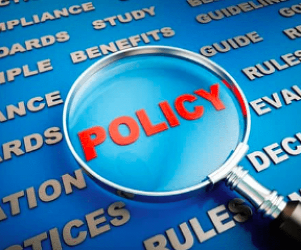 A magnifying glass over the word policy.