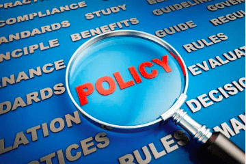 A magnifying glass over the word policy.