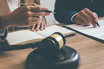 A judge and a lawyer are sitting at the table