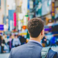 A man in a suit and tie standing on the street.