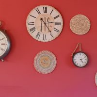 A wall with several different clocks on it.