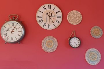 A wall with several different clocks on it.