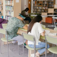 Students studying together at library table