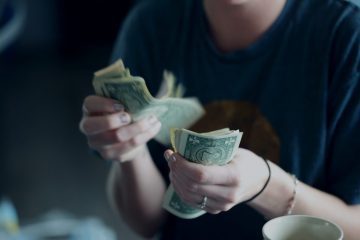 A person holding money in their hands.