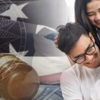 A joyful couple with a gavel and U.S. flag background, symbolizing legal success.