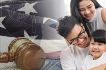 A joyful couple with a gavel and U.S. flag background, symbolizing legal success.